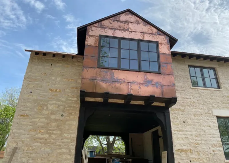 Copper metal panel facade on a stone building for Skylight Installation in Stansbury Park