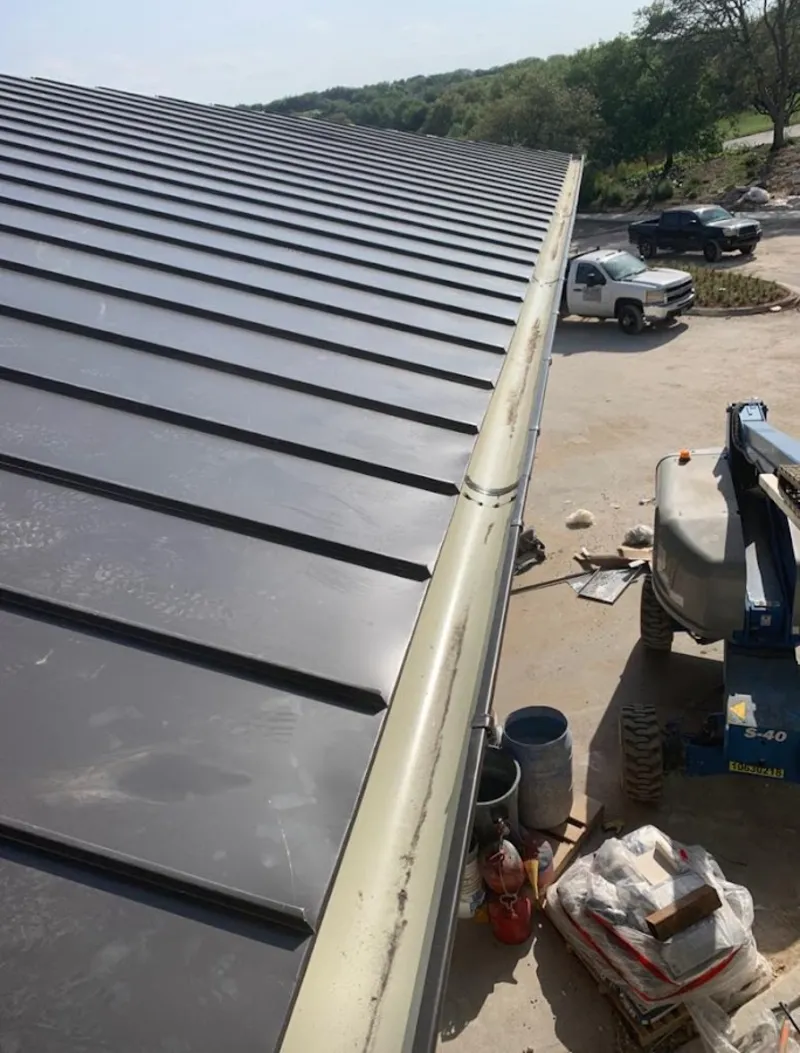 Standing seam panel and gutter detail on a metal roofing jobsite in Stansbury Park
